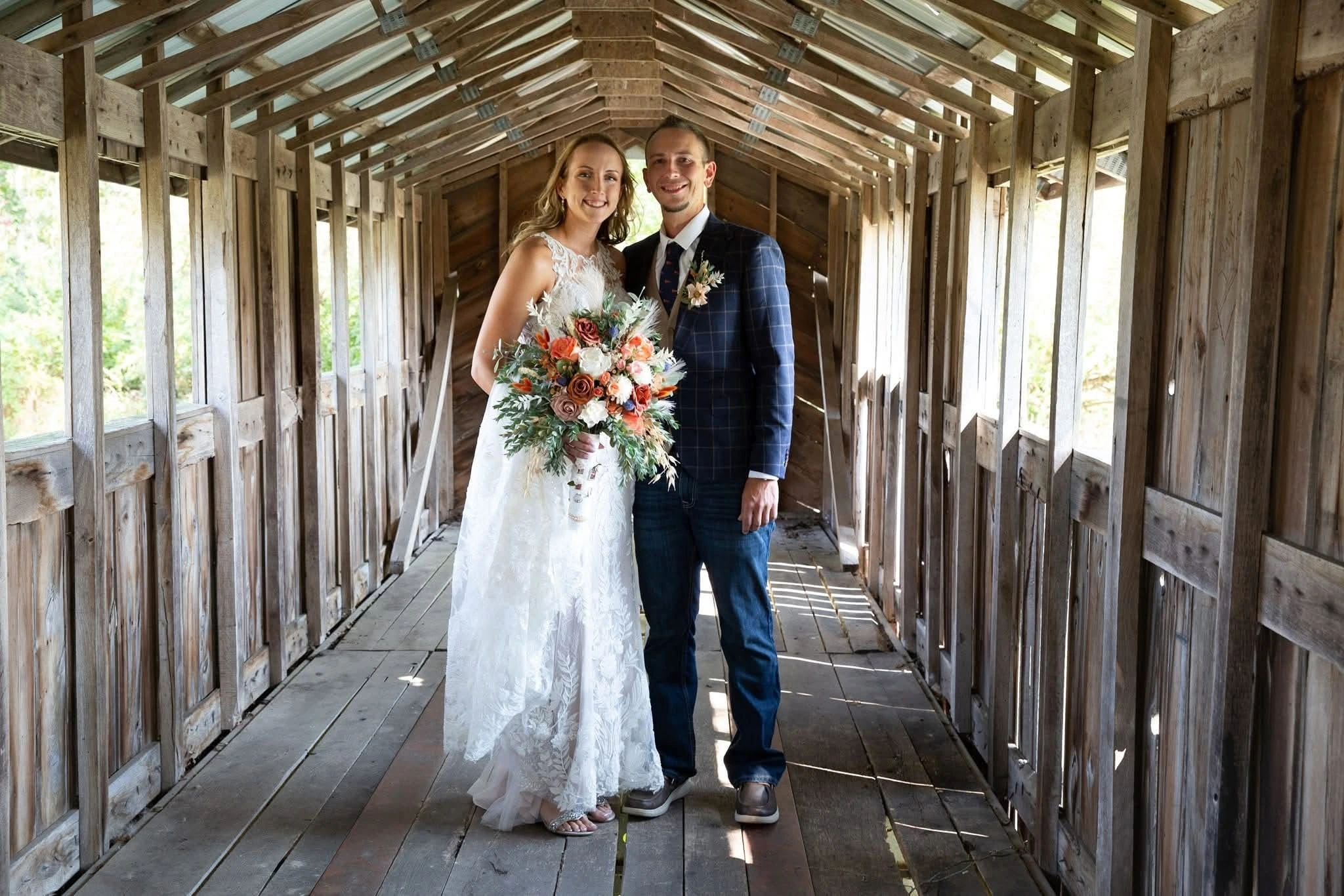 Wedding couple in a wooden covered bridge